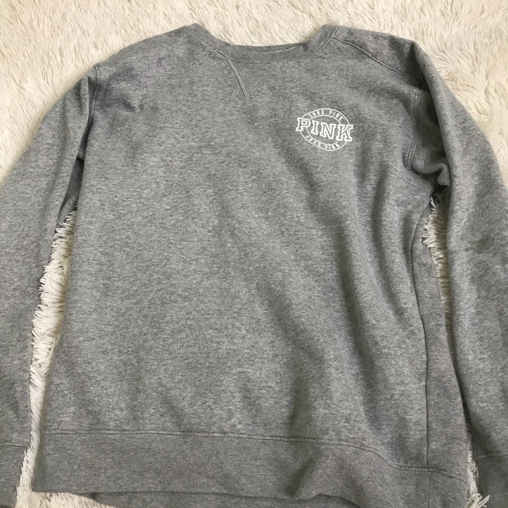 A gray pink sweat shirt
